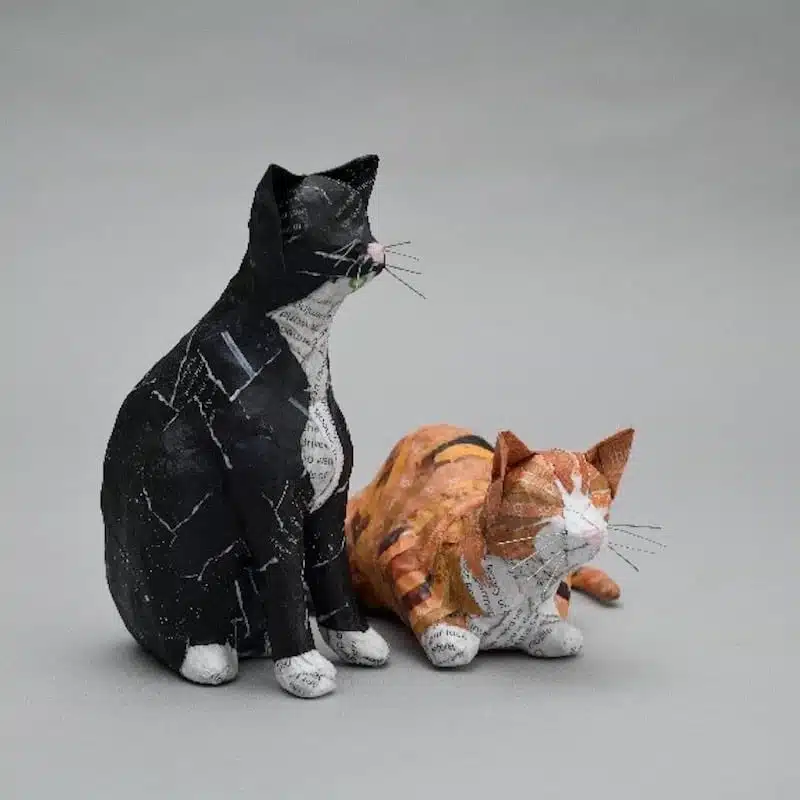 Two papier-mâché cats