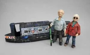 papier mache model of 2 figures with a narrowboat