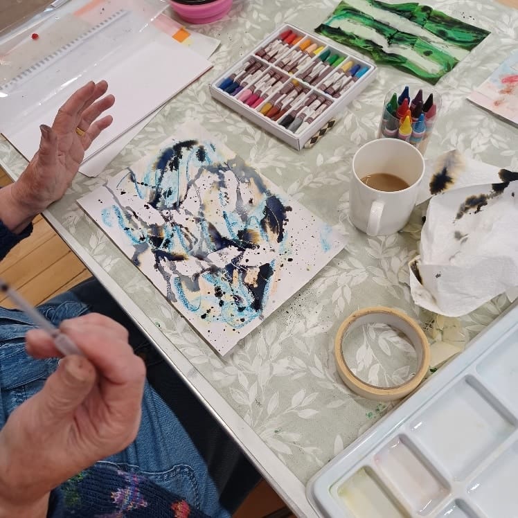 Person creating abstract painting