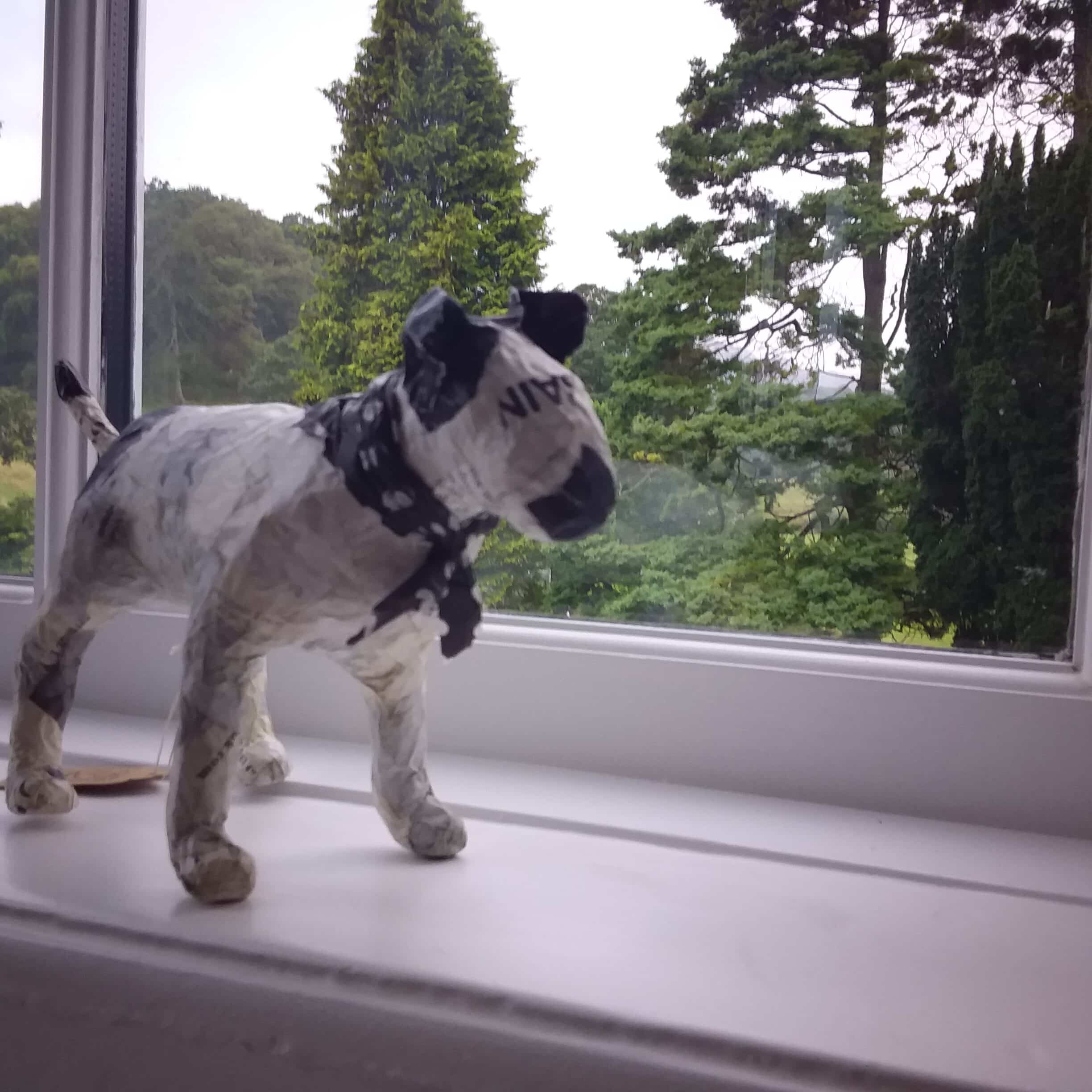 A model of a dog on a window sill