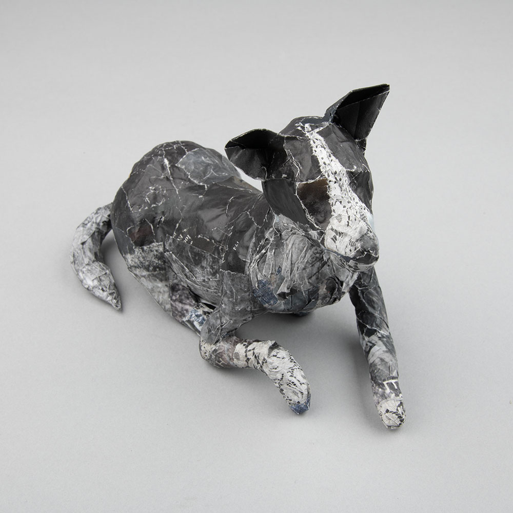 colby2026 A papier mache model of a dog lying down
